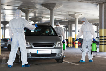 People in protective suits making coronavirus disinfection