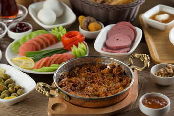 Traditional Turkish Breakfast with sesame bagel and fry egg with sausage.Used ceramic breakfast set and copper egg pan.