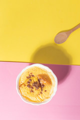 delicious custard in yellow and pink background