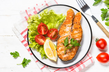 Grilled salmon fish steak on white.