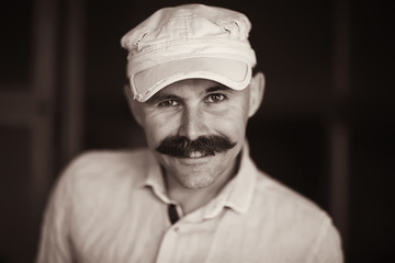 cheerful bald man with a mustache, portrait of a young man smiling, posing, mustachioed mister