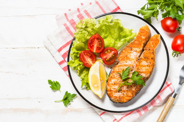 Grilled salmon fish steak on white.