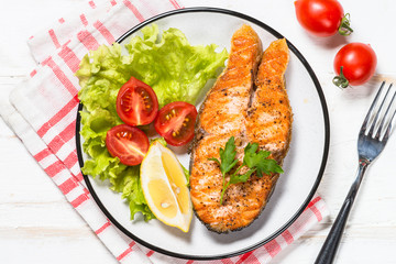 Grilled salmon fish steak on white.