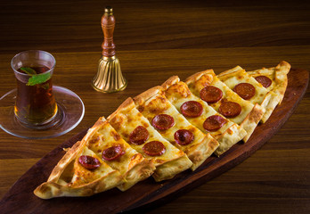 Hot Turkish pide pizza closeup on a wooden table. horizontal top view