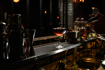 Fototapeta na wymiar Wineglass of icy alcoholic drink stands on bar. .