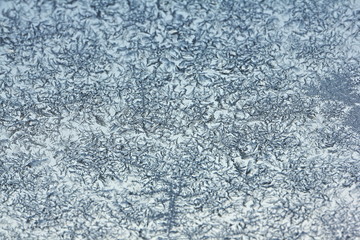 White hoarfrost crystals close up background texture on glass