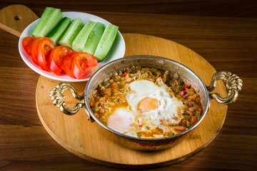 Traditional Turkish Breakfast with sesame bagel and fry egg with sausage.Used ceramic breakfast set and copper egg pan.