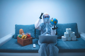 Quarantine and isolation during the virus outbreak - groceries and food in stock, working from home over the internet, holding globe map.