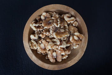 Walnuts in a small wooden bowl