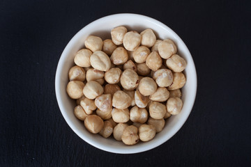 Blanched hazelnuts in a small white bowl
