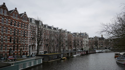 Gloomy Amsterdam row of houses on canal front