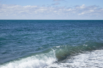 Fototapeta premium Amazing landscape of endless blue sea with waves and foam under boundless sky on sunny summer day
