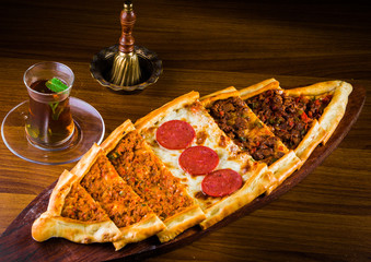 Traditional turkish baked dish pide. Turkish pizza pide, Middle eastern appetizers. Turkish cuisine. Top view. Pide with meat filling.