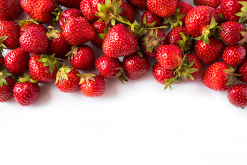 Strawberries on white background. Ripe berries close-up. Strawberries at border of image with copy space. Top view. Background of red berries. Background of fresh strawberries. Various fresh summer.