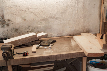 Various carpenter's tools on a wooden table ready for repair.