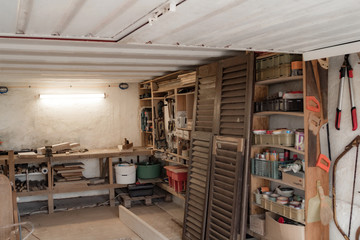 Obraz premium Various carpenter's tools and supplies in a garage.