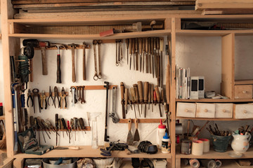 Various carpenter's tools and supplies in a garage.