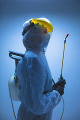Scientist holding chemical sprayer for sterilization and decontamination of viruses, germs, pests,...