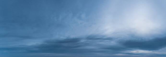 Fantastic clouds against blue sky, panorama