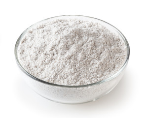 Rye flour in glass bowl isolated on white background with clipping path