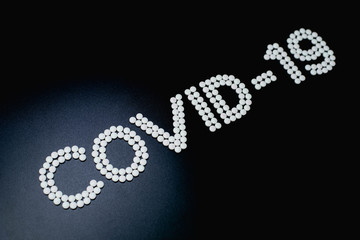 Covid-19 - Wuhan Novel Coronavirus made by many medicine pills isolated on black