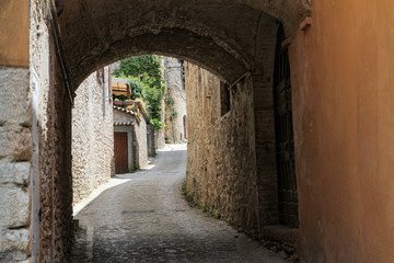 Fototapeta na wymiar a narrow street with narrow passage to the church