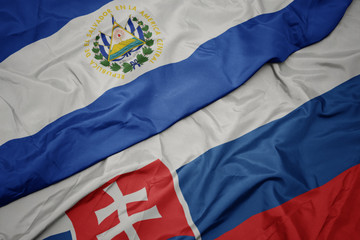 waving colorful flag of slovakia and national flag of el salvador. - obrazy, fototapety, plakaty