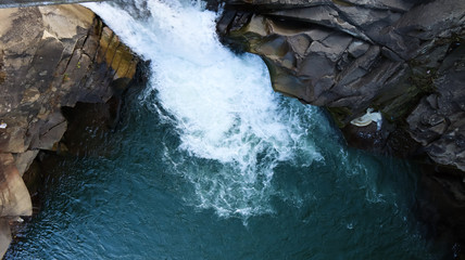 Waterfall top down view. Top view of the stream, water flows over the stones. rocky mountain...