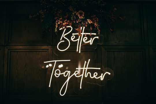 Better Together - neon sign on a brick wall in a restaurant at a wedding party. Love concept	