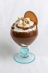 Ice cream cup with different flavors, whipped cream and decorations.