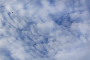 blue sky with white moving slowly clouds abstract nature background