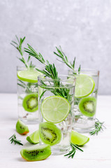 Transparent drink with fruit and rosemary