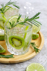 Transparent drink with fruit and rosemary