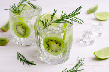 Transparent drink with fruit and rosemary