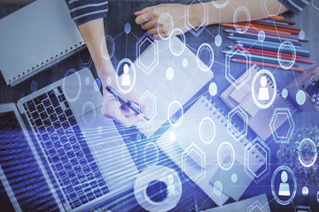 Social network theme hologram over woman's hands writing background. Concept of international people connect. Double exposure