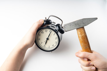 hands and vintage alarm clock and hammer, concept, selective focus, tinted image