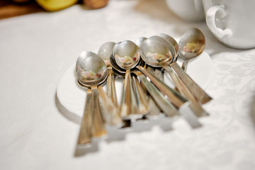 golden spoons on a white plate