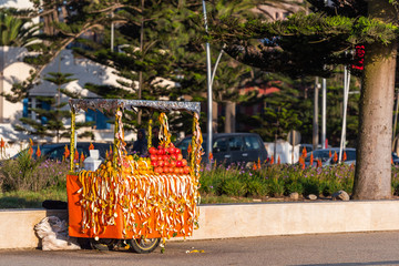 Fresh fruit juices, lemonade vendor stand, Essaouira, Morocco. With selective focus.