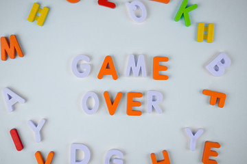 Game over word written with different colored letter blocks on a light background