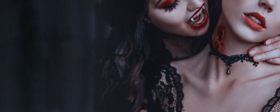 Artwork close up portrait evil medieval vampire woman bites tender cute girl princess. Drop blood red sexy lips. Bloody scary wound bite on neck. Woman's Vampire mouth teeth fangs. Horror bloddy kiss