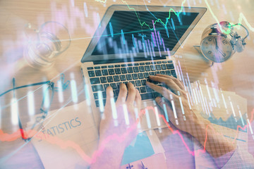 Multi exposure of forex graph with man working on computer on background. Concept of market analysis.