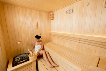 Young woman relaxing in the sauna