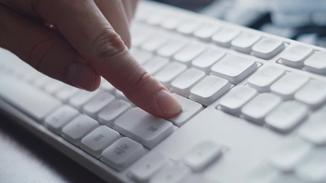 ECU Finger pressing white computer Enter key. Finger pressing multiple times the Enter button on keyboard. Clicks on the keys Enter. Click submit or sent