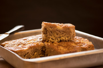 Apple sponge cake, walnuts, flour, sugar, oil and raisins. Delicious homemade dessert.