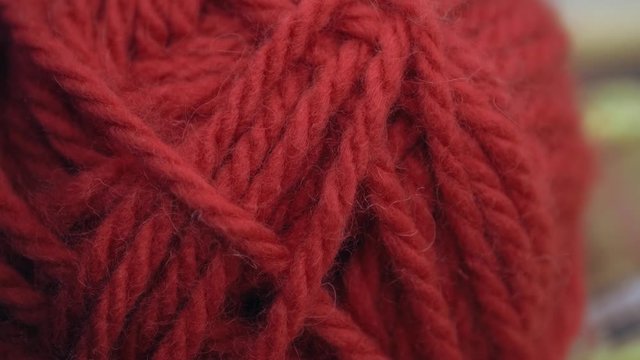 Close-up of red threads for knitting on a shop window