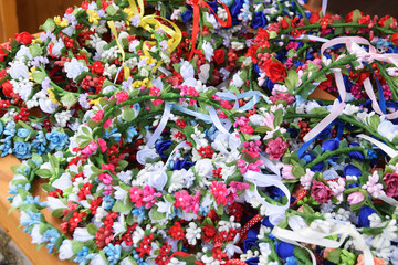 colorful wreaths of artificial flowers