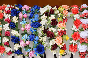 Fototapeta na wymiar colorful wreaths of artificial flowers