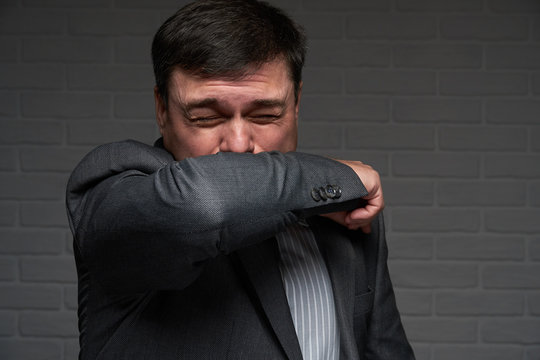 infected man sneezes or coughs and has symptoms of the disease - healthcare and medicine concept