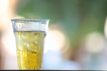 Glass of beer and ice Background image blur.