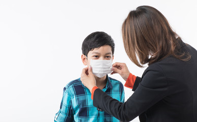 Mother wearing surgical mask for son.